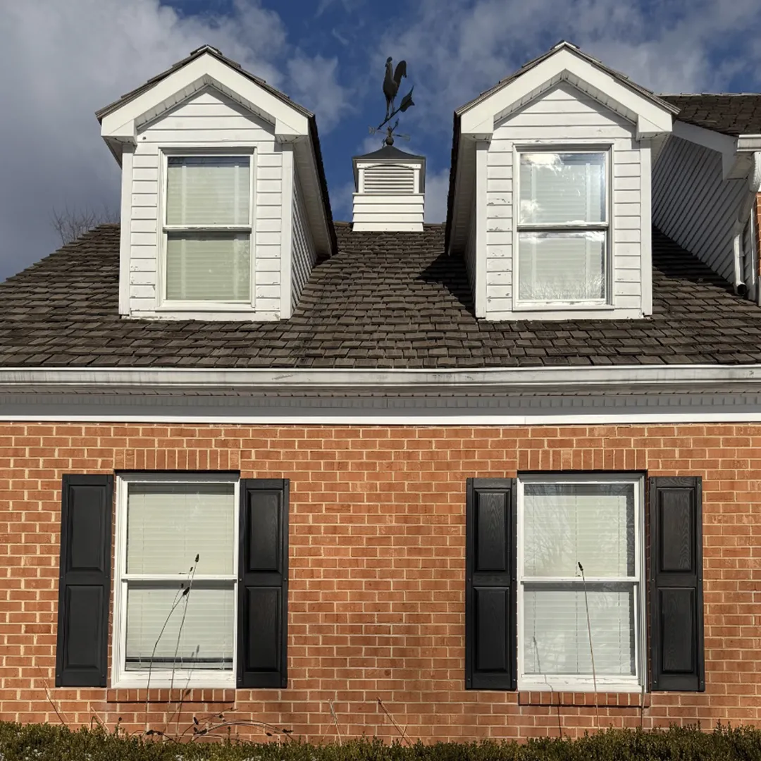 Brick home before dormer and first-floor window replacement