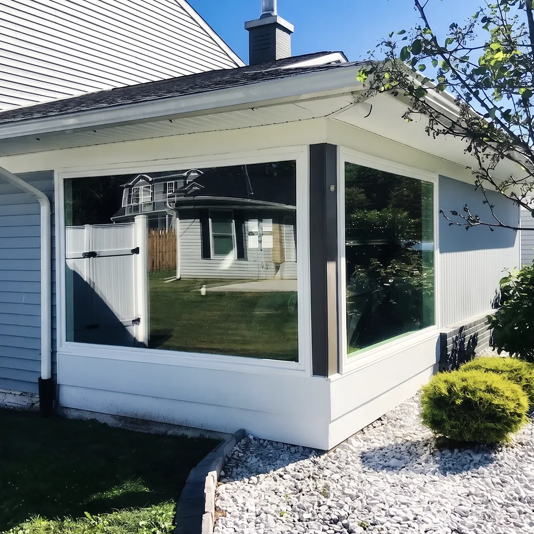 Sunroom exterior after installing black-framed windows