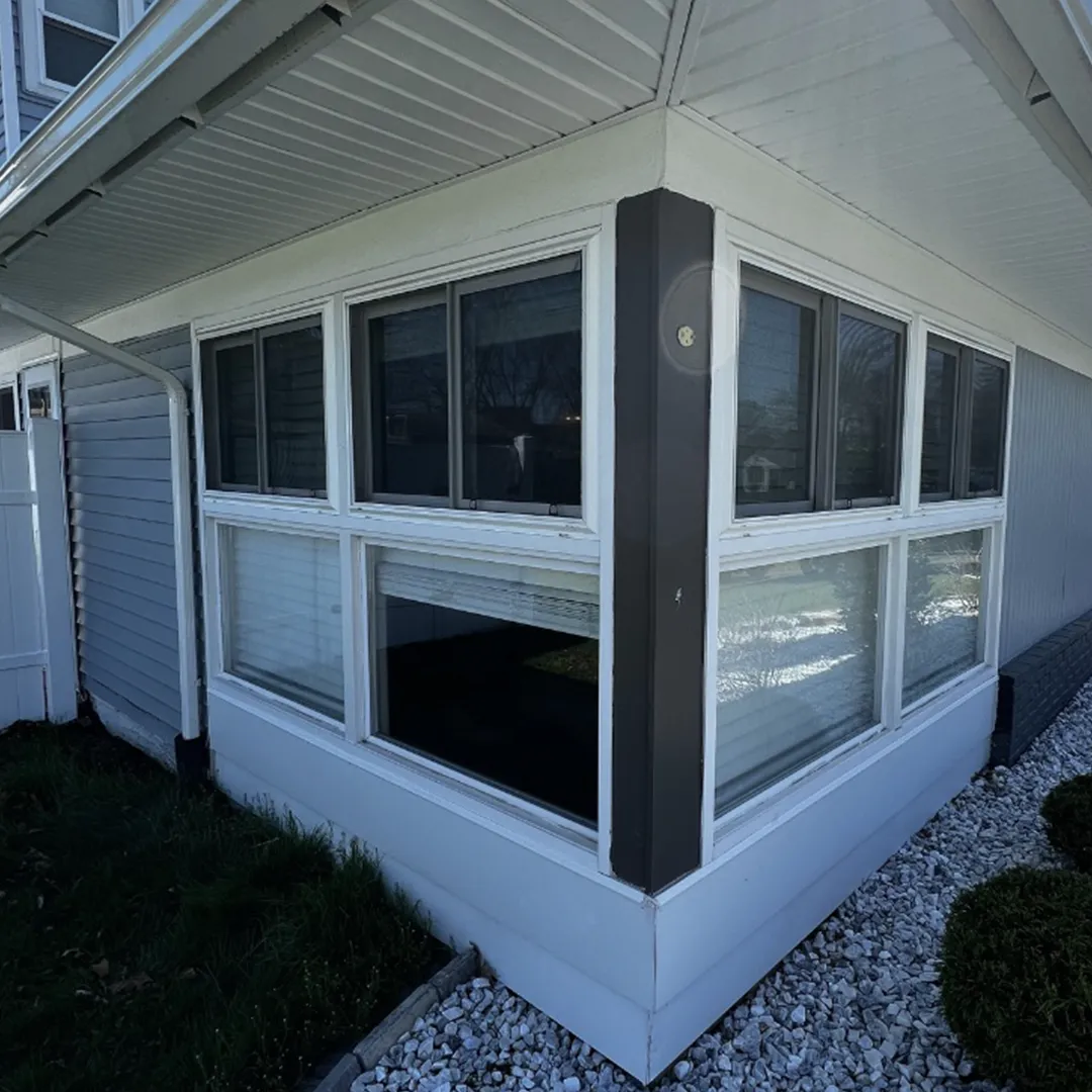 Sunroom exterior before window replacement