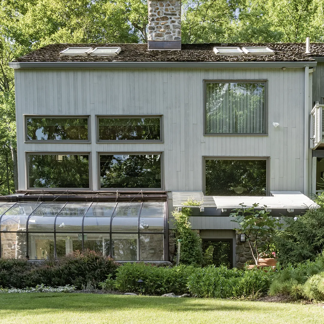 Rear home facade after new white windows were installed