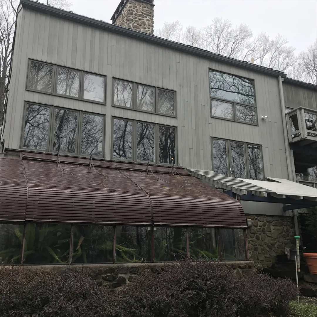 Rear home facade before replacing damaged windows