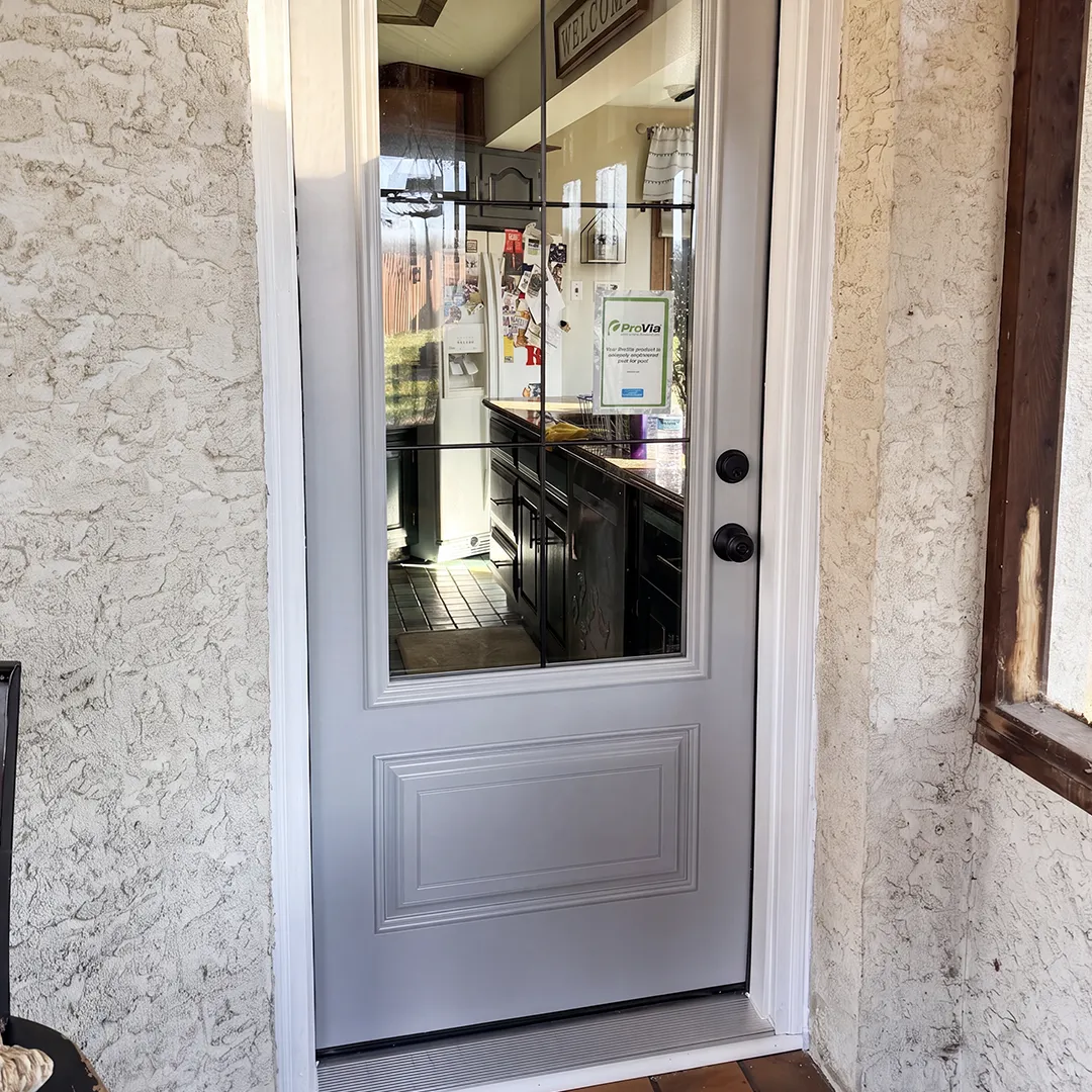 Kitchen entry after installing a gray glass-panel door