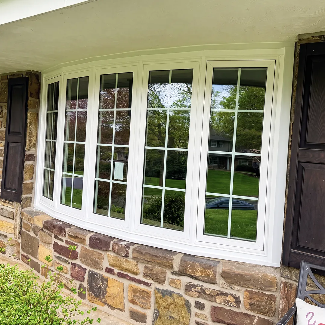 Stone facade after installing white replacement windows