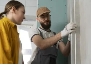 A worker explaining to the client how the door replacement works