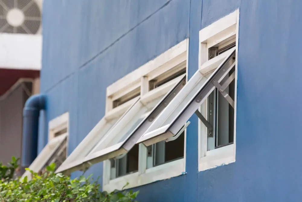 awning style windows on a blue house