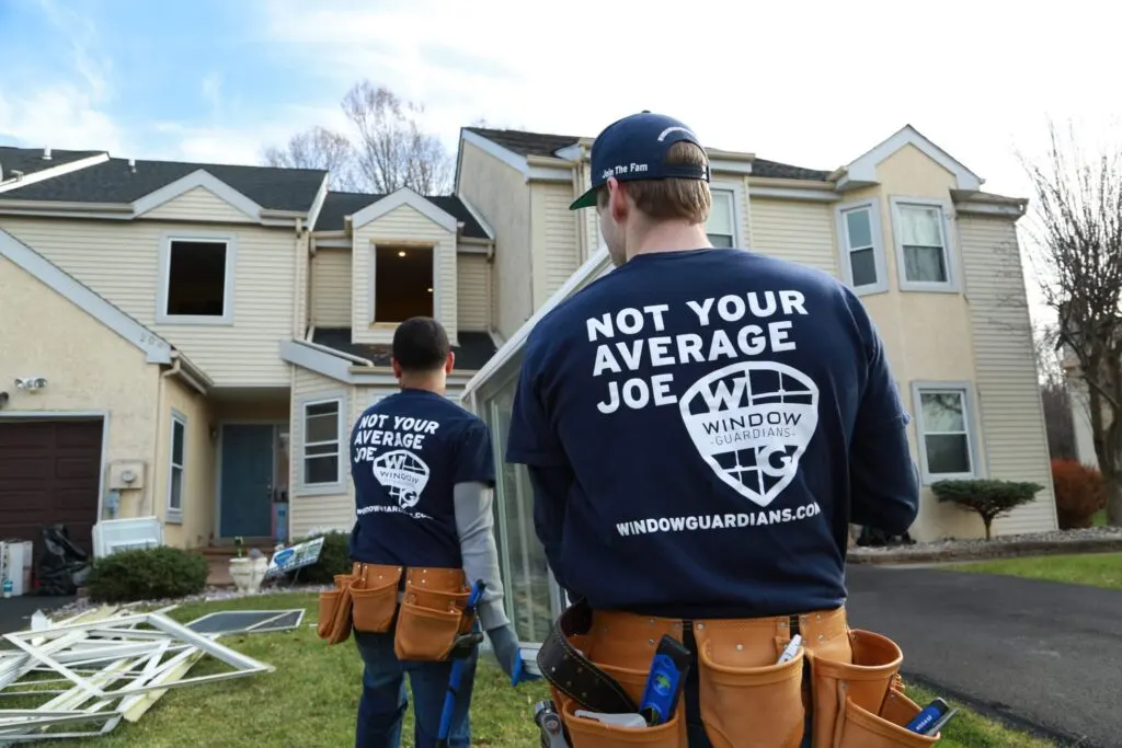 Window Guardians installers preparing replacement windows at a townhouse