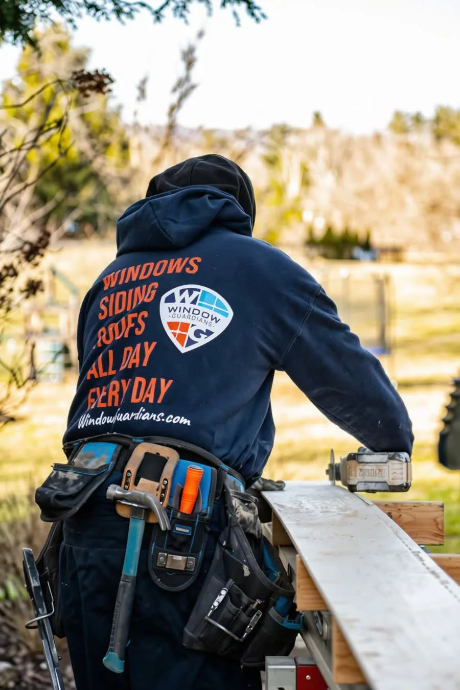 Window Guardians crew member cutting trim at the saw