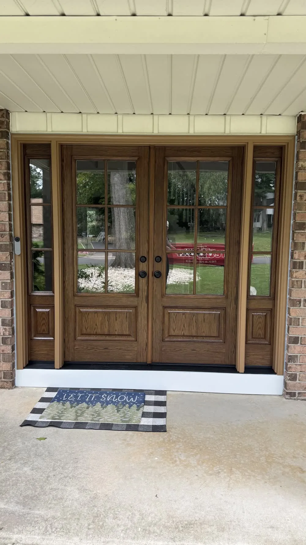Walnut fiberglass double entry door with divided glass and sidelites