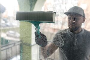 A guy wiping off foggy window