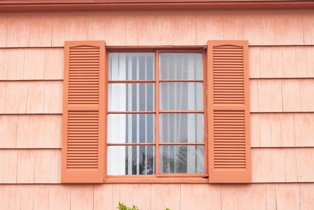 Vintage window with orange tone wall