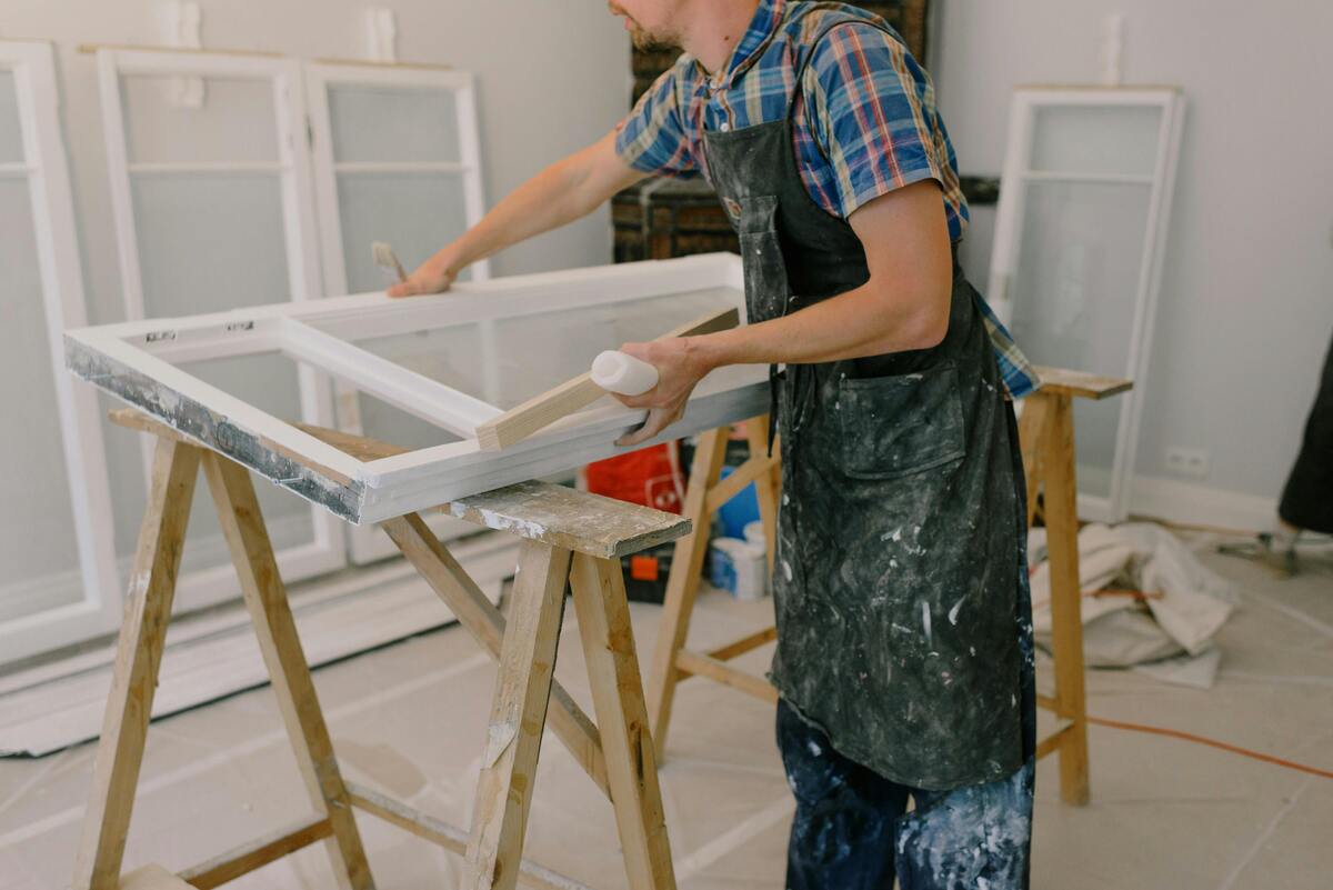 A skilled worker crafting a window