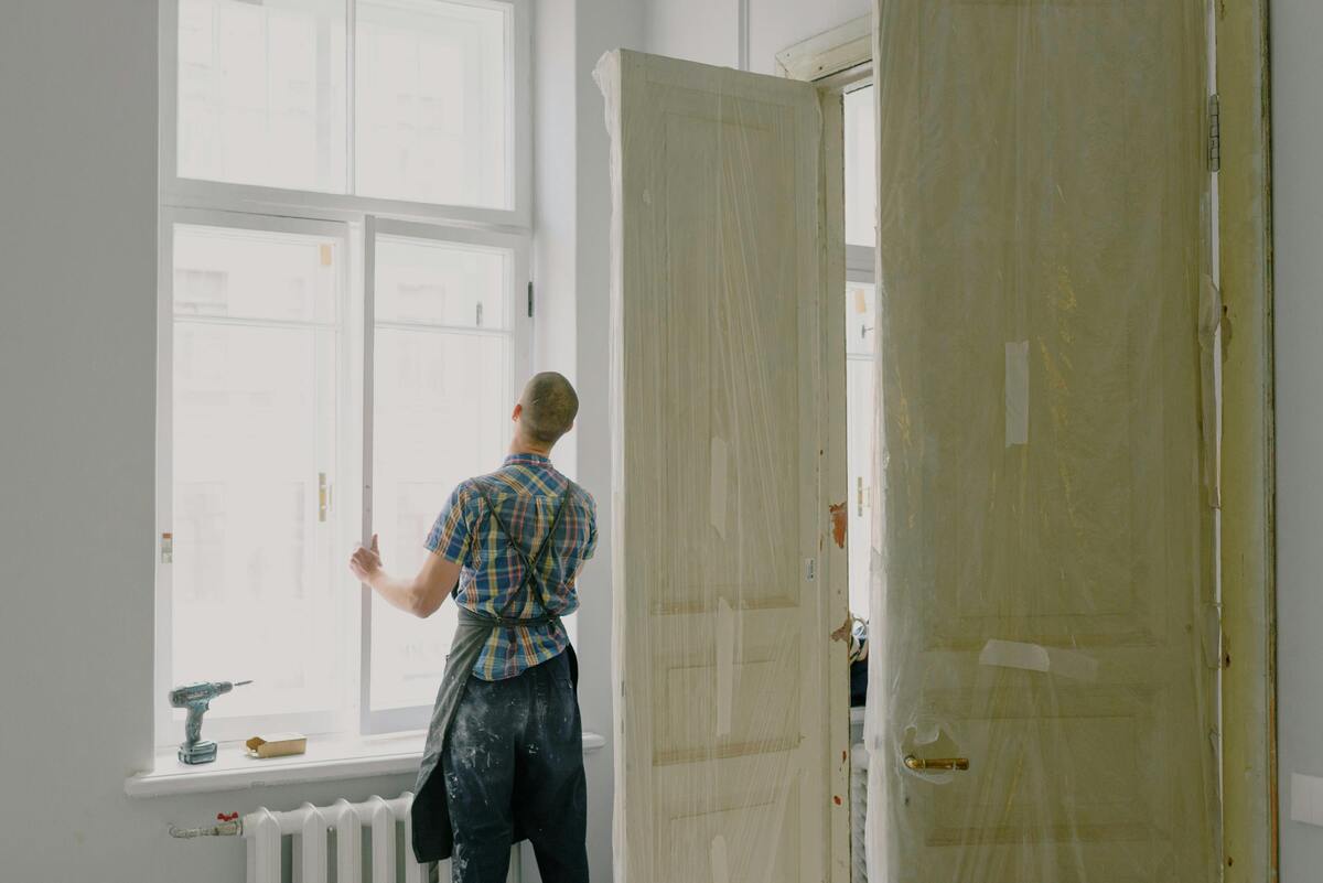 A skilled worker replacing doors and windows