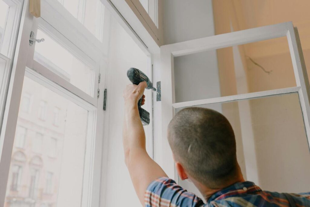 A skilled worker replacing a window